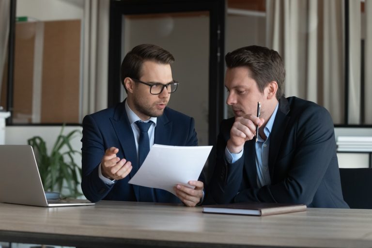 Serious,Young,Man,Supervisor,Analyse,Financial,Report,Of,Responsible,Worker